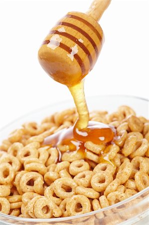 dry cured - Pouring honey on glass bowl of cornflakes. Shallow depth of field Stock Photo - Budget Royalty-Free & Subscription, Code: 400-05136456