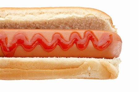A hot dog with ketchup isolated on white background. Shallow depth of field Stock Photo - Budget Royalty-Free & Subscription, Code: 400-05136457