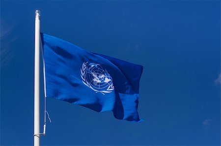 simsearch:400-05136582,k - Waving flag of the United Nations organization against the clear blue sky Stockbilder - Microstock & Abonnement, Bildnummer: 400-05136588