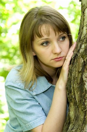 The beautiful girl in park to stand near an old tree Stock Photo - Budget Royalty-Free & Subscription, Code: 400-05137619