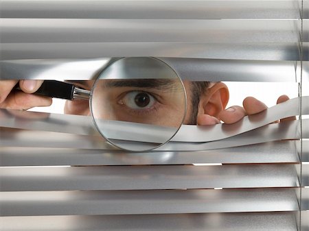 peeking store window - A man is peeping through the blinds with a magnifying glass. Photographie de stock - Aubaine LD & Abonnement, Code: 400-05138463