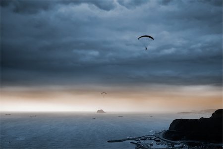 skydiving silhouette - It is a kind of sport called parachuting over the sea. Stock Photo - Budget Royalty-Free & Subscription, Code: 400-05138500
