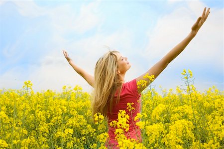 simsearch:400-04982004,k - happy blond girl with open arms in a big hug to the sky in a yellow field Stock Photo - Budget Royalty-Free & Subscription, Code: 400-05138759