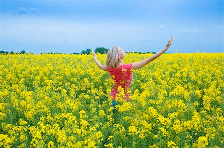 simsearch:400-04982004,k - happy blond girl with open arms to the sky smilimg in a yellow field Stock Photo - Budget Royalty-Free & Subscription, Code: 400-05138760