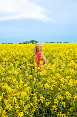 simsearch:400-04982004,k - cute young woman in pink t-shirt smiling in a yellow field Stock Photo - Budget Royalty-Free & Subscription, Code: 400-05138761