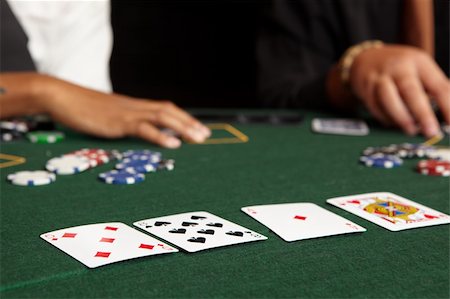 Playing cards, chips and players gambling around a green felt poker table. Shallow Depth of field Stock Photo - Budget Royalty-Free & Subscription, Code: 400-05138852