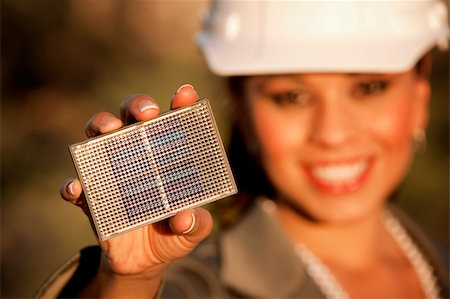 Pretty young woman wearing hardhat with small solar panel in hand Stock Photo - Budget Royalty-Free & Subscription, Code: 400-05139344
