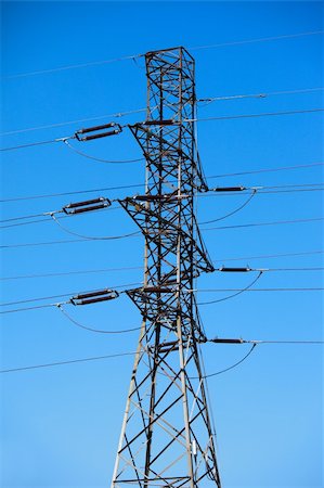 electricity pole - High tension electric pole against blue cloudless sky Stock Photo - Budget Royalty-Free & Subscription, Code: 400-05139424