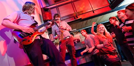 deejay (female) - Guitarist and saxophone player, accompanied by a DJ, during a gig with an enthousiastic crowd in a discotheque Stock Photo - Budget Royalty-Free & Subscription, Code: 400-05139443