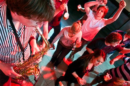 party sax images - Saxophonist playing in a nightclub, with dancing people in the background Stock Photo - Budget Royalty-Free & Subscription, Code: 400-05139502