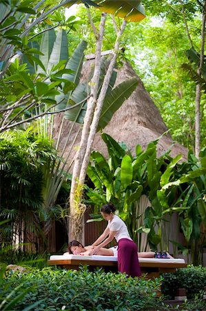 eastwestimaging (artist) - A young woman getting a massage in a tropical spa Foto de stock - Super Valor sin royalties y Suscripción, Código: 400-05139813