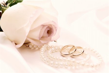 Retro picture of a rose, pearl necklace and wedding rings over white satin Stock Photo - Budget Royalty-Free & Subscription, Code: 400-05139963