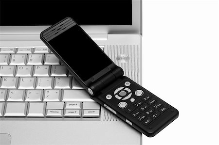 simsearch:400-04412834,k - Mobile phone on the keyboard of a laptop Stock Photo - Budget Royalty-Free & Subscription, Code: 400-05130265