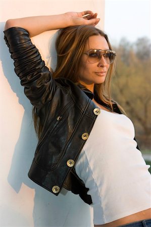 Young brunette in sunglasses standing at the column Stock Photo - Budget Royalty-Free & Subscription, Code: 400-05130408