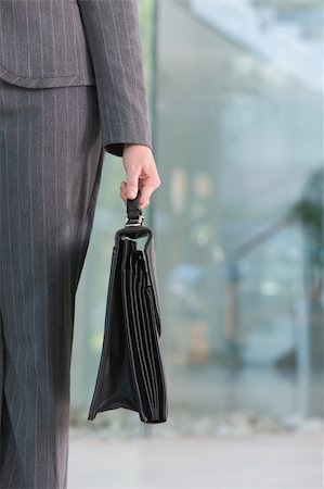 business woman carrying briefacse Stock Photo - Budget Royalty-Free & Subscription, Code: 400-05130747