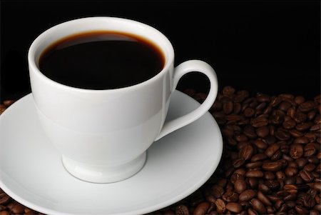 simsearch:400-03971684,k - Cup of coffee. A background with coffee grains and a white cup. A photo close up Foto de stock - Super Valor sin royalties y Suscripción, Código: 400-05130837