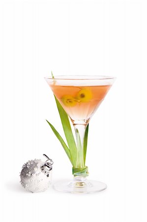 A view of a full martini glass garnished with greenery and a silver Christmas ball. Stock Photo - Budget Royalty-Free & Subscription, Code: 400-05131695