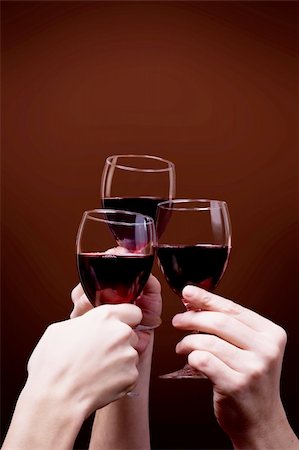 glass of red wine in hand on brown background Stock Photo - Budget Royalty-Free & Subscription, Code: 400-05131700