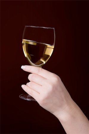 glass of white wine in hand on brown background Stock Photo - Budget Royalty-Free & Subscription, Code: 400-05131701