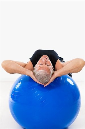 senior man working out on fitness ball and looking at camera. Copy space Stock Photo - Budget Royalty-Free & Subscription, Code: 400-05132160