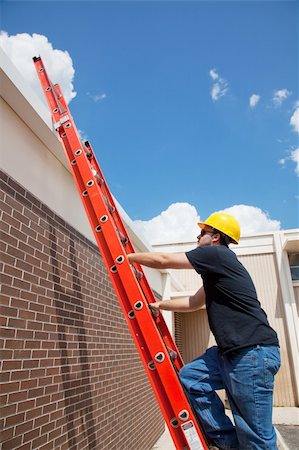 Construction worker climbing up a ladder to the roof of a building. Stock Photo - Budget Royalty-Free & Subscription, Code: 400-05132561