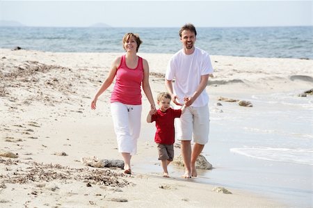 young happy family taking a walk along the beach Stock Photo - Budget Royalty-Free & Subscription, Code: 400-05133127