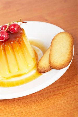 Vanilla cream caramel dessert with red currants and two cookies on white dish. Shallow depth of field Stock Photo - Budget Royalty-Free & Subscription, Code: 400-05133908