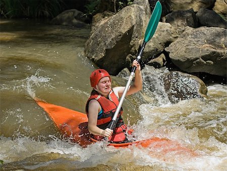 great image of a teenage facing the ordeals and challenge of white water kayaking Stock Photo - Budget Royalty-Free & Subscription, Code: 400-05144054