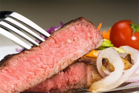 fresh juicy beef ribeye steak sliced ,with lemon and orange peel on top  and vegetable beside Stock Photo - Budget Royalty-Free & Subscription, Code: 400-05144280