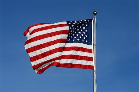 simsearch:400-08998198,k - American flag waving against blue sky Foto de stock - Super Valor sin royalties y Suscripción, Código: 400-05144456