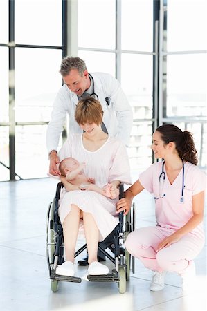 Doctors helping patient and newborn baby in hospital Stock Photo - Budget Royalty-Free & Subscription, Code: 400-05145041