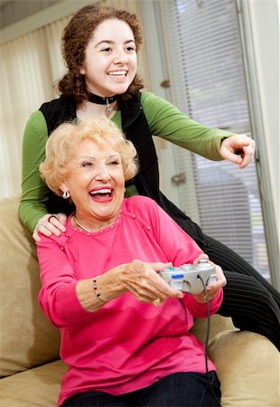 simsearch:400-04300757,k - Grandmother and teen granddaughter having a great time playing video games. Photographie de stock - Aubaine LD & Abonnement, Code: 400-05145088