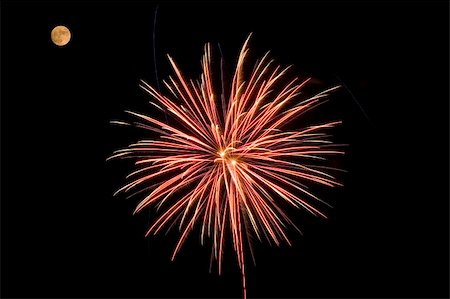 simsearch:400-06477770,k - A red and yellow fireworks bursting near the moon. Photographie de stock - Aubaine LD & Abonnement, Code: 400-05145395