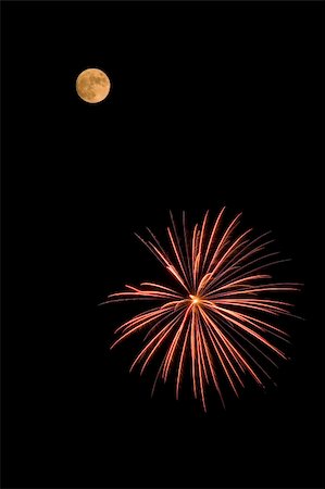 simsearch:400-06477770,k - A red and yellow fireworks bursting near the moon. Photographie de stock - Aubaine LD & Abonnement, Code: 400-05145396