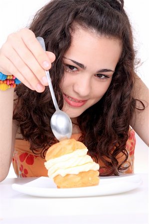 Young girl eating a yumy cake Stock Photo - Budget Royalty-Free & Subscription, Code: 400-05145730