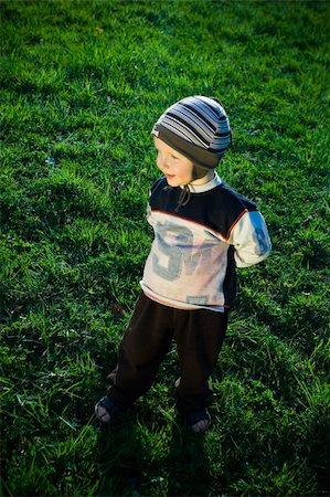 reverie - boy standing on a meadow and smiles Stock Photo - Budget Royalty-Free & Subscription, Code: 400-05146071