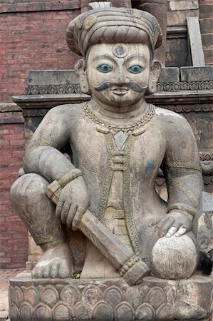 Statue of mythical person guarding the steps of the ancient Nyatopola Temple in Bhaktapur, Nepal Stock Photo - Budget Royalty-Free & Subscription, Code: 400-05146084