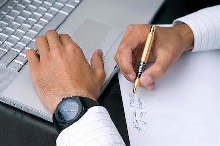 ertekmali (artist) - A close-up of a businessman's hands working on a computer and writing down ideas. Stockbilder - Microstock & Abonnement, Bildnummer: 400-05146130