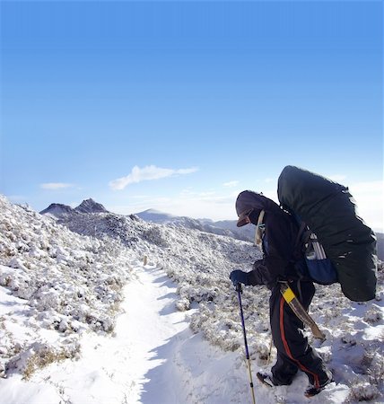 There was a backpacker with heavy pack walk on the snow. Stock Photo - Budget Royalty-Free & Subscription, Code: 400-05146572