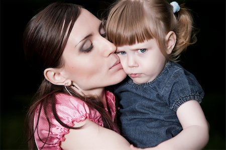 simsearch:400-06073989,k - Mother Kissing Daughter Cheek. Close-Up Portrait Photographie de stock - Aubaine LD & Abonnement, Code: 400-05146787