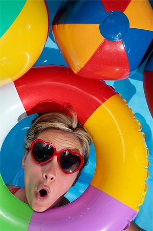 swimming pool candid - Woman having fun with an Inflatable Rubber Ring Stock Photo - Budget Royalty-Free & Subscription, Code: 400-05147406