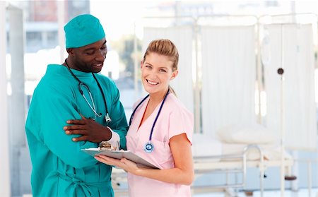 Surgeon and nurse examining a patient report in hospital Stock Photo - Budget Royalty-Free & Subscription, Code: 400-05147606