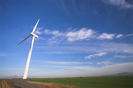 simsearch:400-03912255,k - Wind powered electricity generator standing against the blue sky in a green field on the wind farm Stock Photo - Budget Royalty-Free & Subscription, Code: 400-05147659