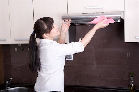 young brunette woman cleaning kitchen Stock Photo - Budget Royalty-Free & Subscription, Code: 400-05148024