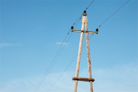 Old wooden electric pillar against blue sky Stock Photo - Budget Royalty-Free & Subscription, Code: 400-05148414
