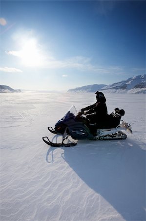 A snowmobile on frozen ice on a barren winter landscape Stock Photo - Budget Royalty-Free & Subscription, Code: 400-05140155