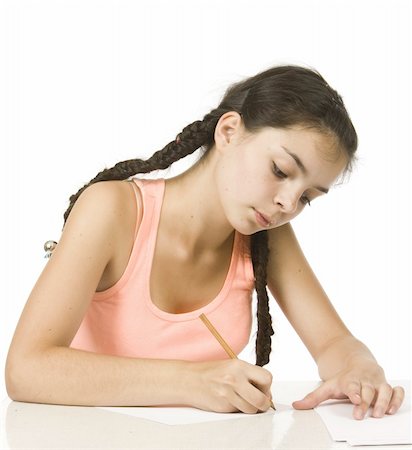 simsearch:400-06517383,k - Young girl with plaits writes with concentration Fotografie stock - Microstock e Abbonamento, Codice: 400-05140673