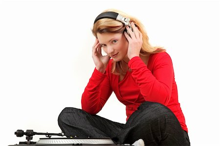 Portrait of young woman listening to record with headphones, studio shot Stock Photo - Budget Royalty-Free & Subscription, Code: 400-05140699