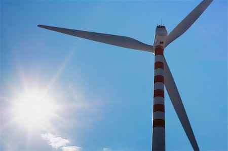 Modern and ecologic wind turbine silhuette beside the bright sun Foto de stock - Super Valor sin royalties y Suscripción, Código: 400-05141495