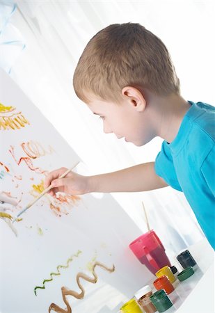 sergeitelegin (artist) - The boy draws with interest paints on a white cloth Stock Photo - Budget Royalty-Free & Subscription, Code: 400-05143659